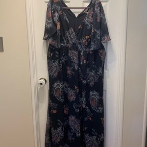 Maternity maxi dress, navy in color with floral designs.